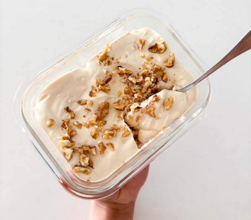 A spoonful of smooth and crunchy Carrot Cake Overnight Weetbix with Voomie Flow Fuel, served fresh with chopped walnuts.